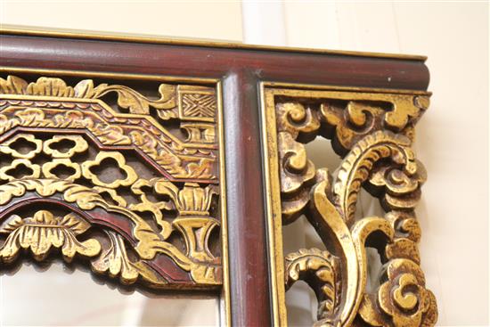 A Chinese carved and parcel-gilt wall mirror W.122cm